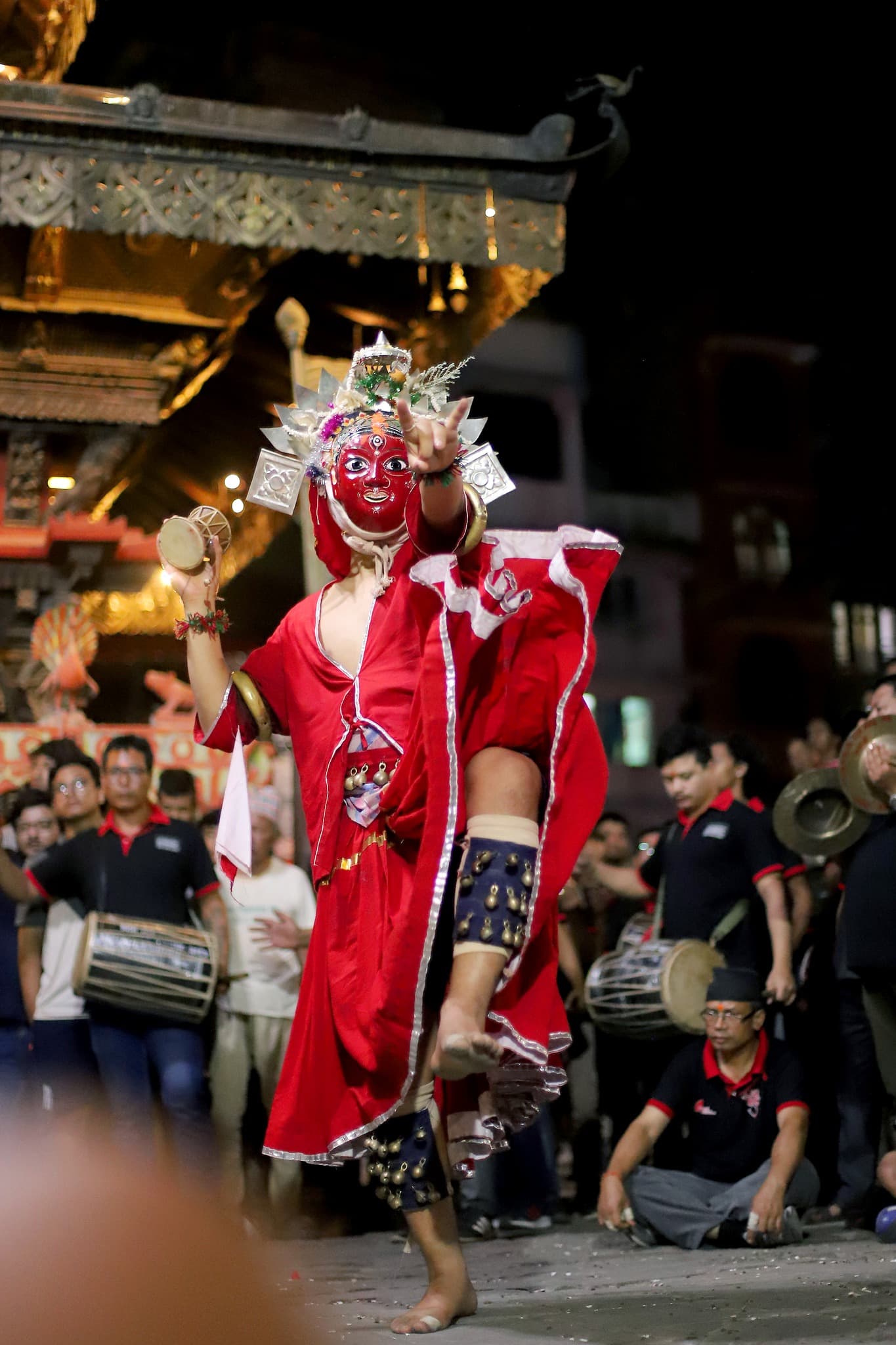 Festival performer in a night ceremony near temple space in Thimi.